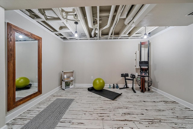 workout area with wood finished floors and baseboards