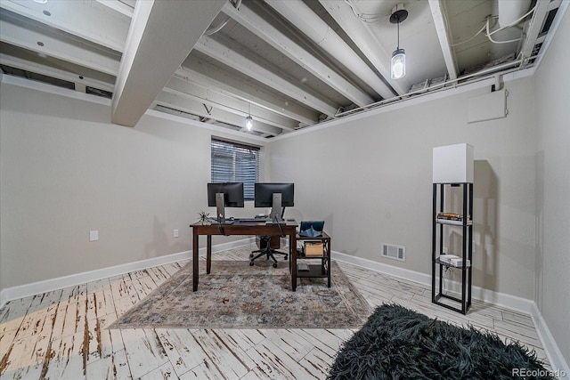 office area featuring visible vents, baseboards, and wood finished floors