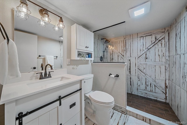 full bath featuring vanity, toilet, a walk in shower, and wood finish floors