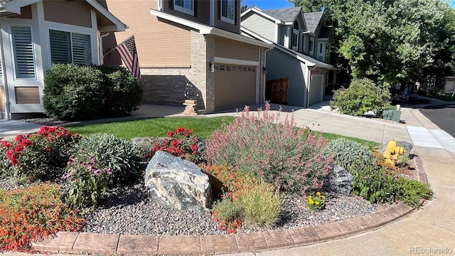 view of home's exterior with concrete driveway, a garage, and brick siding