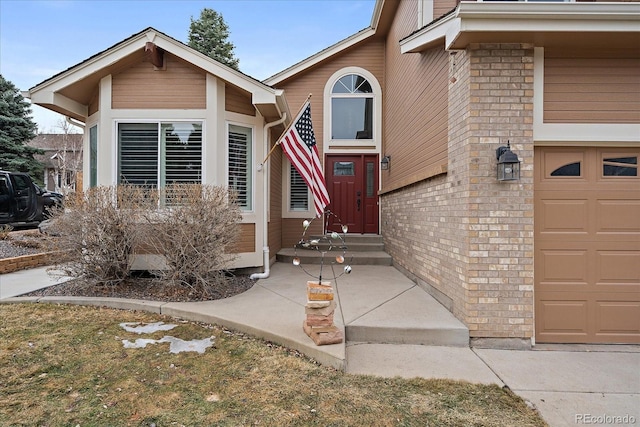 exterior space featuring a garage and brick siding