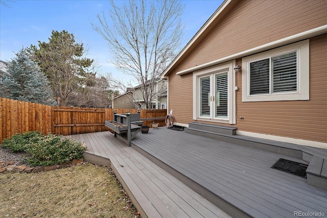 wooden terrace with entry steps and a fenced backyard