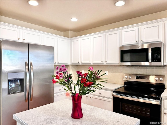4788 Laurelglen Ln, Highlands Ranch, CO 80130 - kitchen featuring stainless steel appliances, white cabinetry, light countertops, backsplash, and recessed lighting