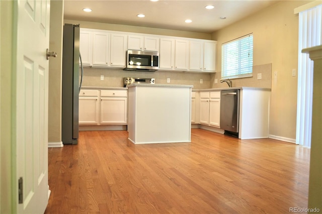 4788 Laurelglen Ln, Highlands Ranch, CO 80130 - kitchen with appliances with stainless steel finishes, decorative backsplash, recessed lighting, and white cabinetry