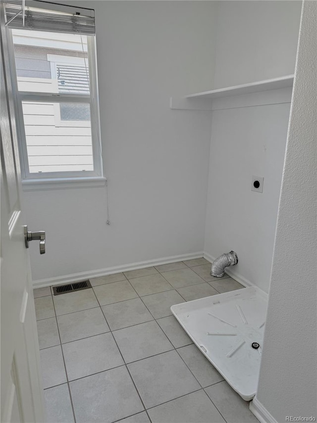 4788 Laurelglen Ln, Highlands Ranch, CO 80130 - laundry area featuring electric dryer hookup and light tile patterned flooring