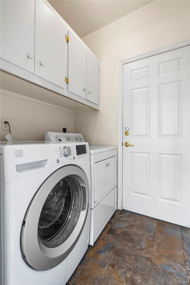 3000 E 112th Ave Unit 86, Northglenn, CO 80233 - laundry room with cabinet space, washer and clothes dryer, and dark stone finish flooring