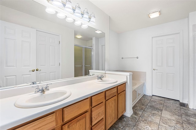 3000 E 112th Ave Unit 86, Northglenn, CO 80233 - bathroom featuring a shower stall, a garden tub, double vanity, and stone finish floors