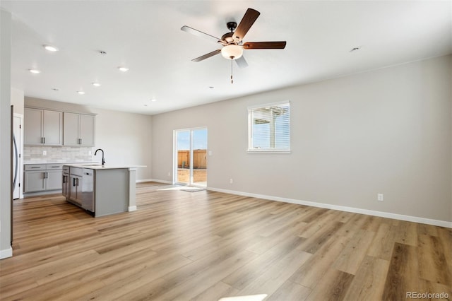 17942 E 94th Pl, Commerce City, CO 80022 - kitchen featuring gray cabinets, open floor plan, light countertops, light wood finished floors, and ceiling fan