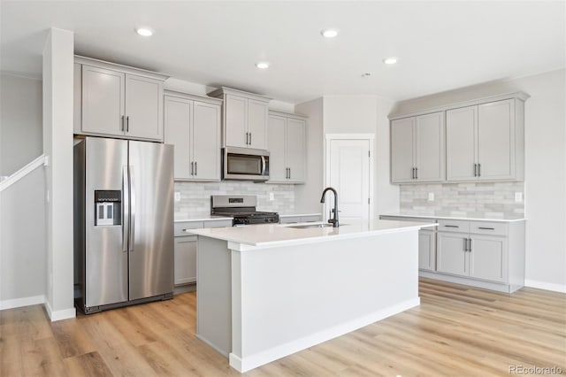 17942 E 94th Pl, Commerce City, CO 80022 - kitchen featuring appliances with stainless steel finishes, gray cabinets, light wood-style flooring, and recessed lighting