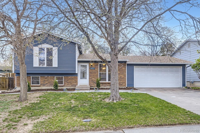 tri-level home with brick siding, driveway, a garage, entry steps, and a front lawn