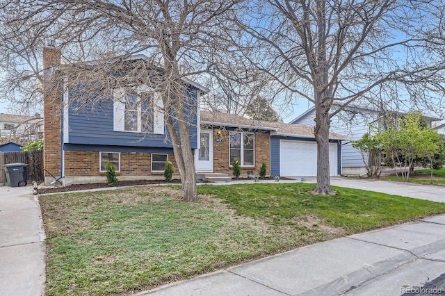 tri-level home with a chimney, a front lawn, a garage, and fence