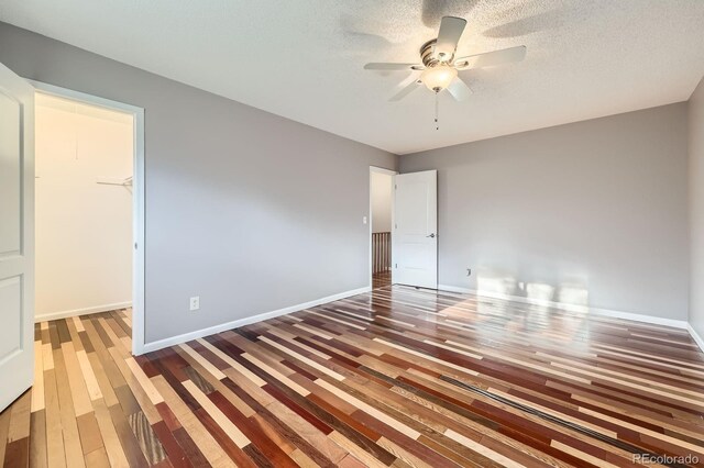 9921 Wigham St, Thornton, CO 80229 - unfurnished bedroom with baseboards, a spacious closet, and wood finished floors
