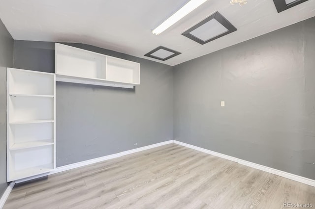 unfurnished bedroom with baseboards and wood finished floors