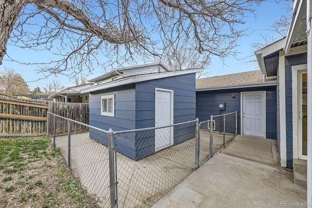 view of side of home with fence and a gate