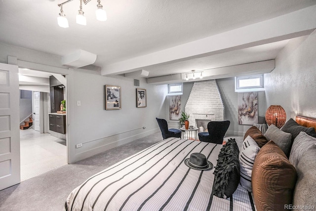 carpeted bedroom featuring track lighting, visible vents, and baseboards