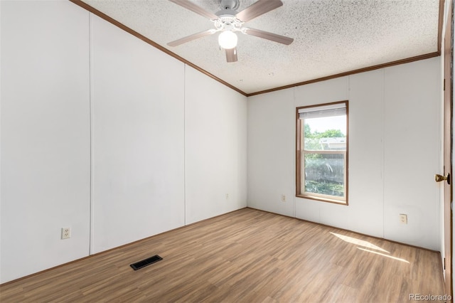 unfurnished room with ornamental molding, a textured ceiling, wood finished floors, and a ceiling fan