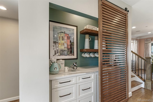 5880 Beeler Ct, Denver, CO 80238 - bar area featuring wood finished floors, ornamental molding, recessed lighting, baseboards, and stairs