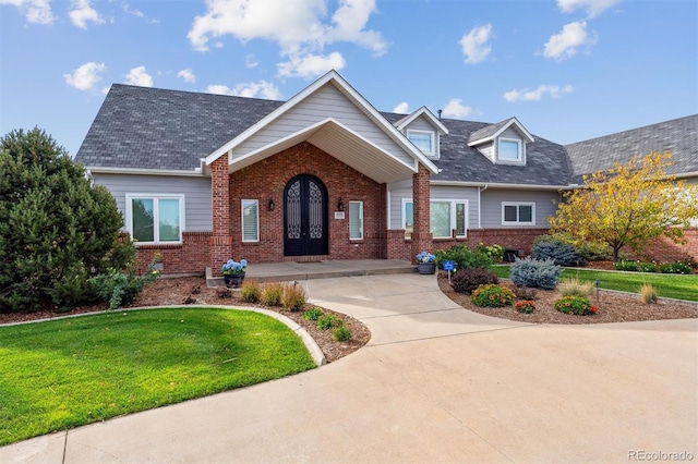29850 E 167th Pl, Brighton, CO 80603 - view of front facade featuring brick siding, a front yard, and french doors