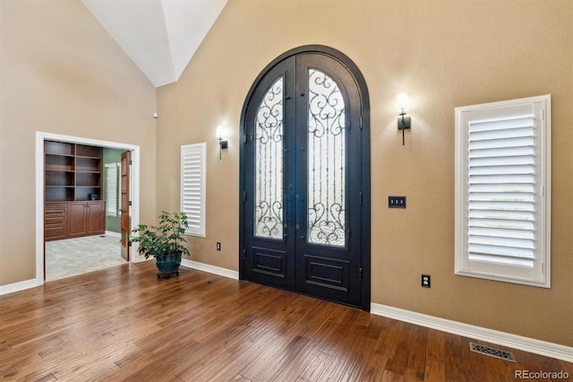 29850 E 167th Pl, Brighton, CO 80603 - entryway featuring arched walkways, french doors, wood finished floors, baseboards, and vaulted ceiling