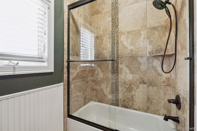 bathroom with shower / bath combination with glass door and plenty of natural light