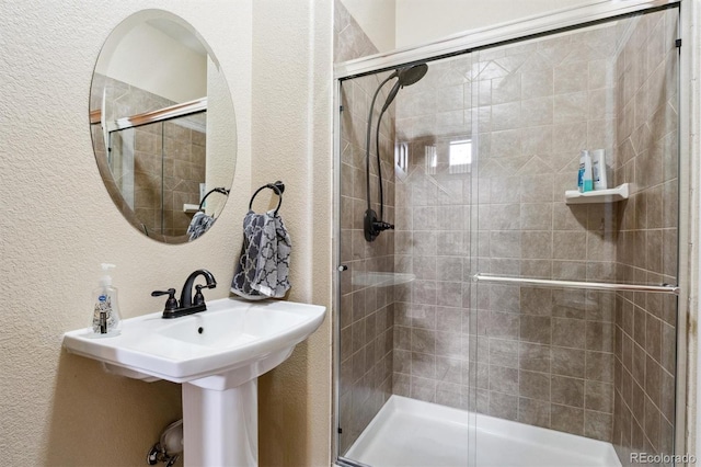 29850 E 167th Pl, Brighton, CO 80603 - bathroom featuring a textured wall, a stall shower, and a sink