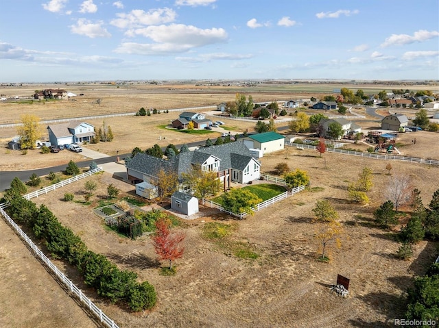 birds eye view of property with a rural view