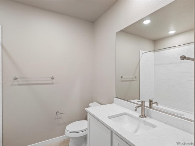 bathroom with vanity, toilet, and walk in shower