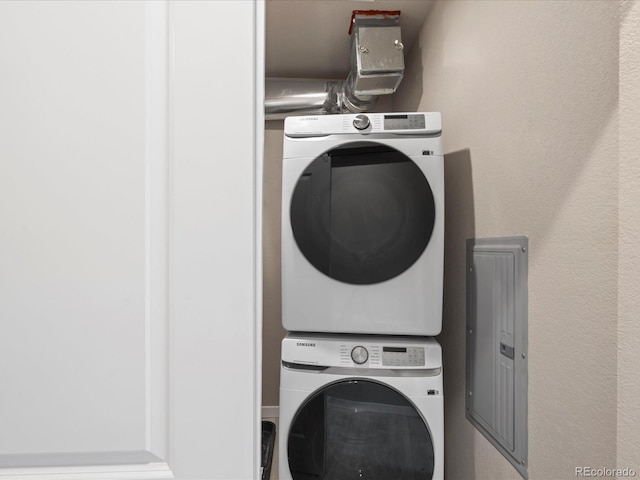 laundry area with stacked washer and clothes dryer