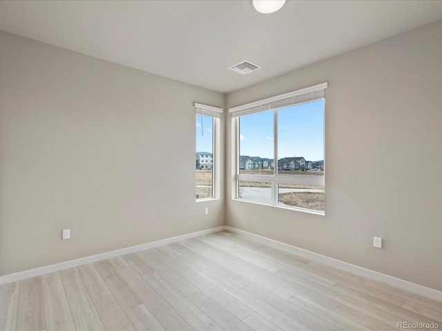 unfurnished room featuring light hardwood / wood-style floors