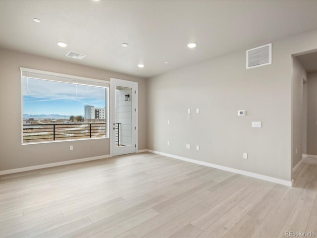 spare room with light hardwood / wood-style flooring