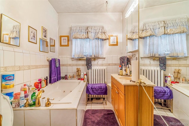 2421 N York St, Denver, CO 80205 - bathroom featuring radiator heating unit, tile patterned flooring, vanity, a jetted tub, and tile walls