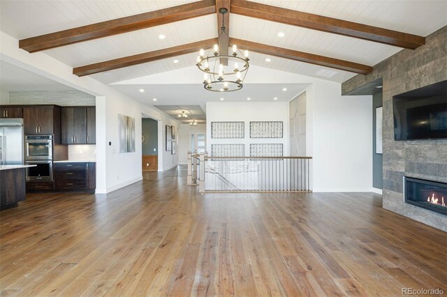27381 E Lakeview Dr, Aurora, CO 80016 - unfurnished living room featuring a chandelier, light wood-style floors, a tiled fireplace, recessed lighting, and baseboards