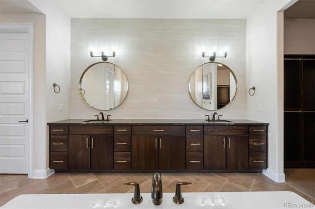 27381 E Lakeview Dr, Aurora, CO 80016 - bathroom featuring double vanity and baseboards