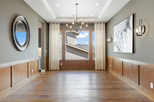 27381 E Lakeview Dr, Aurora, CO 80016 - unfurnished dining area with a raised ceiling, a chandelier, wood-type flooring, wainscoting, and recessed lighting