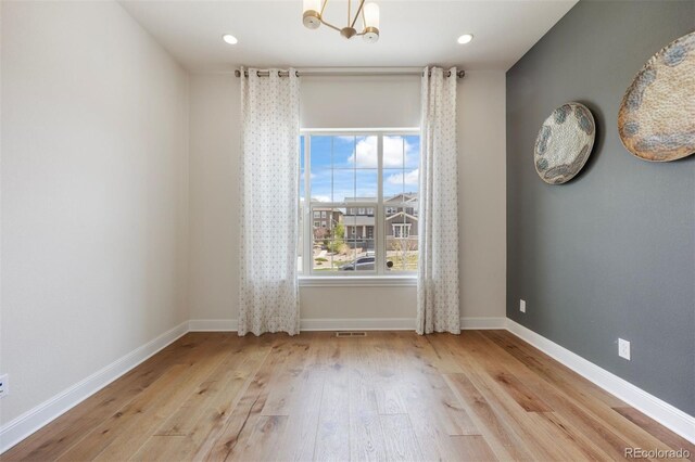 27381 E Lakeview Dr, Aurora, CO 80016 - spare room with wood-type flooring, a chandelier, baseboards, and recessed lighting