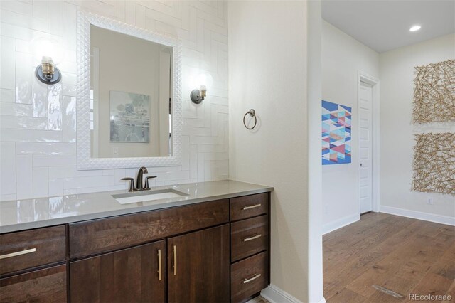 27381 E Lakeview Dr, Aurora, CO 80016 - bathroom featuring wood finished floors, baseboards, vanity, and recessed lighting