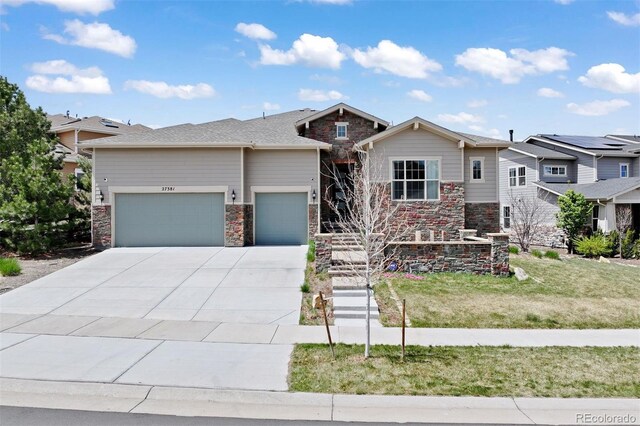 27381 E Lakeview Dr, Aurora, CO 80016 - view of front of property featuring an attached garage, stone siding, driveway, and a front lawn
