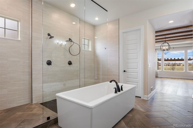 27381 E Lakeview Dr, Aurora, CO 80016 - full bathroom featuring healthy amount of natural light, a freestanding bath, a walk in shower, a chandelier, and recessed lighting