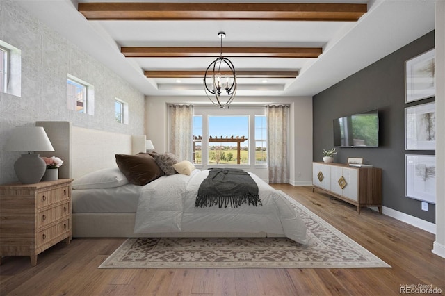 27381 E Lakeview Dr, Aurora, CO 80016 - bedroom with wood finished floors, an accent wall, and beam ceiling
