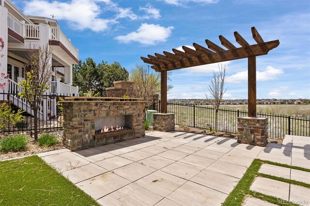 27381 E Lakeview Dr, Aurora, CO 80016 - view of patio featuring an outdoor stone fireplace and a pergola