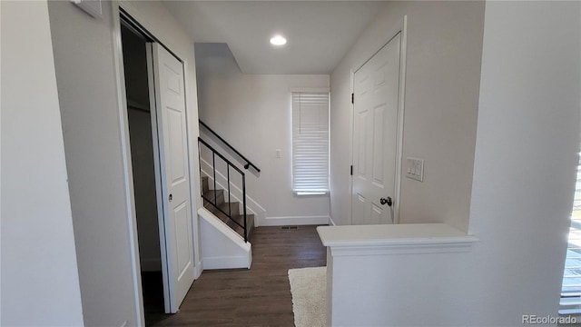 foyer entrance featuring baseboards, stairway, dark wood finished floors, and recessed lighting