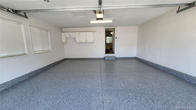 garage with baseboards and a garage door opener