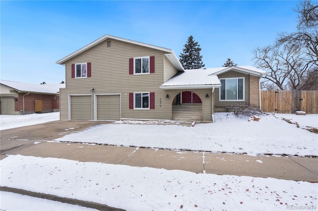 split level home featuring fence