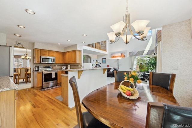 5134 S Ouray Ct, Centennial, CO 80015 - dining space featuring a chandelier, light wood-style floors, and recessed lighting