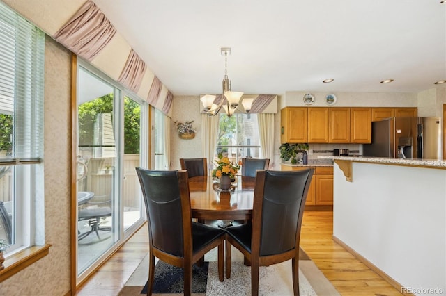 5134 S Ouray Ct, Centennial, CO 80015 - dining area with light wood-type flooring, a chandelier, and wallpapered walls