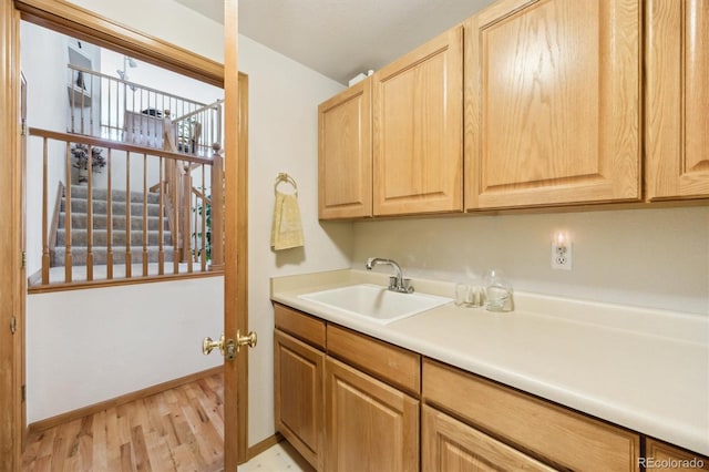 5134 S Ouray Ct, Centennial, CO 80015 - kitchen with a sink, light wood-style flooring, light brown cabinets, baseboards, and light countertops