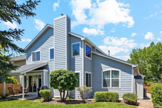 5134 S Ouray Ct, Centennial, CO 80015 - back of property with a patio and a chimney