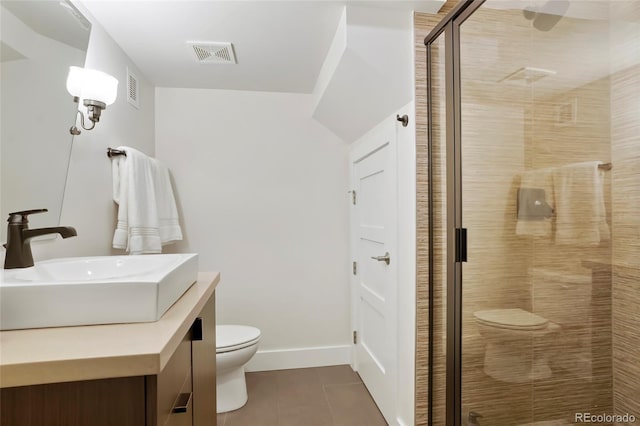 bathroom with tile patterned flooring, vanity, a shower with shower door, and toilet