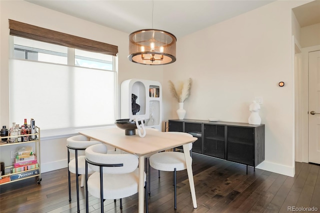 dining space featuring dark hardwood / wood-style floors and a notable chandelier