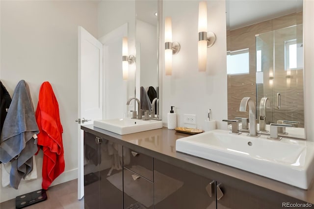 bathroom with vanity and a shower with shower door